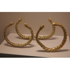 Gold twisted bracelets with dog heads at the tip